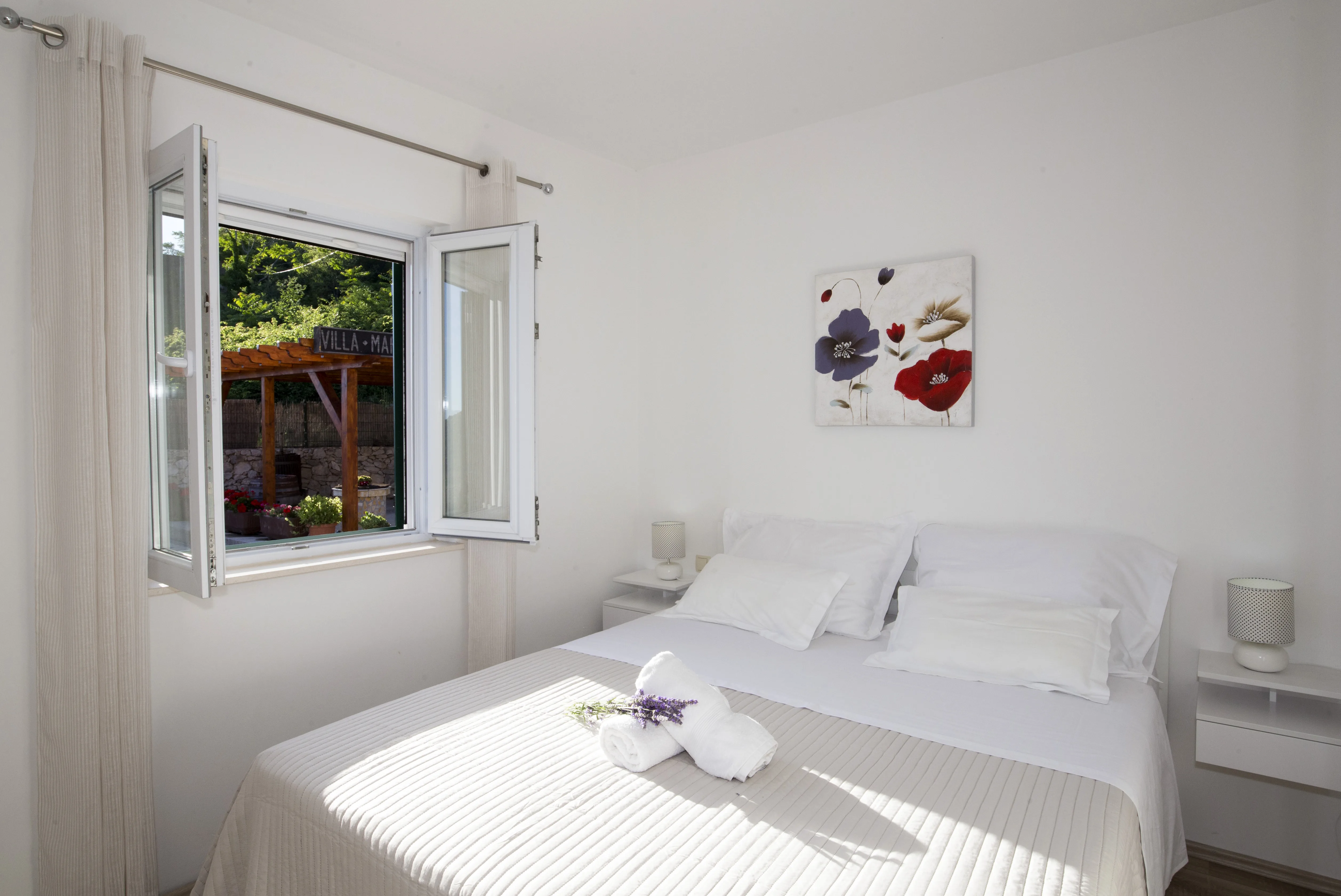 Bedroom 1 — double bed with garden view
